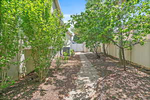 Fenced backyard featuring a gate