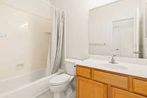 Full bathroom featuring vanity, shower / tub combo with curtain, and tile patterned floors