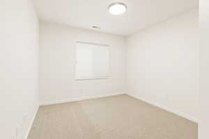Empty room with carpet floors and baseboards