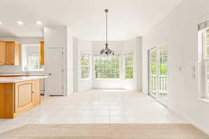 Unfurnished dining area with a chandelier, light tile patterned floors, and recessed lighting