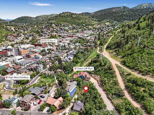 Aerial view of property's location with a mountainous background