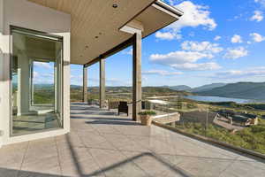 View of patio featuring a water and mountain view