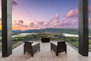 Patio terrace at dusk featuring a mountain view