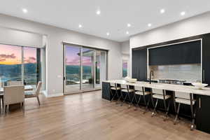 Dining space with recessed lighting and light wood-style flooring