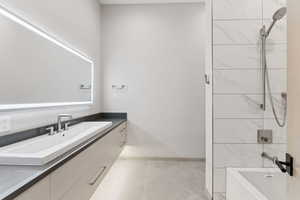 Full bath with vanity, tub / shower combination, and tile patterned flooring