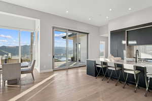 Dining room featuring a mountain view, plenty of natural light, light wood-type flooring, and recessed lighting