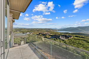 Balcony featuring a water and mountain view