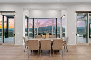 Dining area with a mountain view and wood finished floors