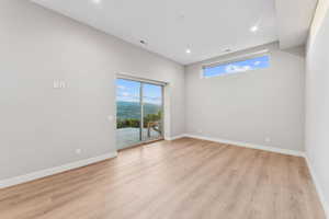 Spare room with light wood-type flooring and recessed lighting