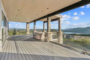 Deck with a water and mountain view