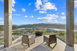 View of patio with a water and mountain view