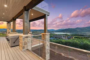 Deck at dusk featuring a mountain view