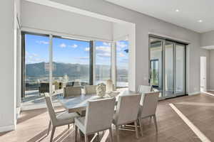 Dining room with a mountain view, wood-type flooring, and recessed lighting