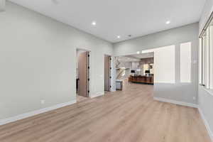Unfurnished living room featuring light wood finished floors and recessed lighting