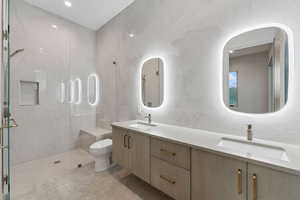 Bathroom featuring tile walls, double vanity, a stall shower, recessed lighting, and tile patterned flooring