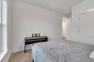 Bedroom with carpet flooring and baseboards