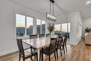Dining room featuring light wood finished floors, recessed lighting, and a chandelier
