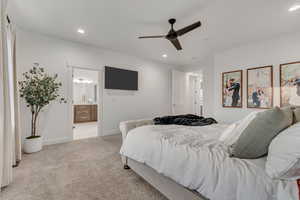 Carpeted bedroom featuring recessed lighting, connected bathroom, and a ceiling fan