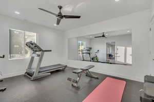 Workout room featuring ceiling fan and recessed lighting