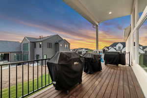 Deck at dusk featuring area for grilling and a residential view