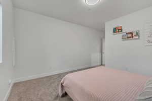 Carpeted bedroom with baseboards