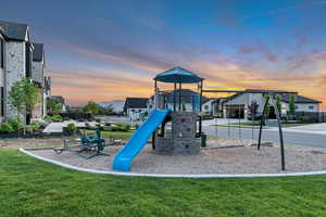 Playground at dusk featuring a lawn