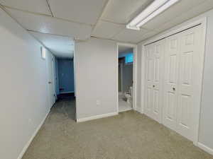 Finished basement featuring carpet flooring and baseboards