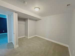 Finished basement with carpet floors and baseboards