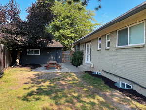 Fenced backyard featuring entry steps and a patio
