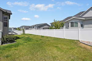 Fenced backyard featuring a residential view and stairs