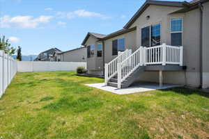 Fenced backyard with a patio area
