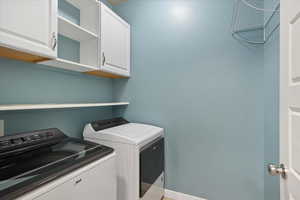 Washroom with washing machine and dryer and cabinet space