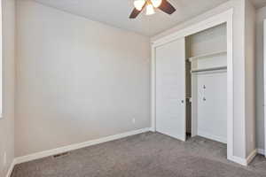 Unfurnished bedroom with carpet, a closet, and ceiling fan