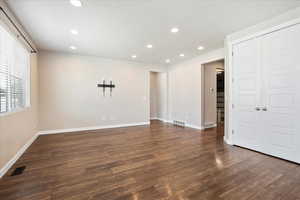 Spare room with wood finished floors and recessed lighting