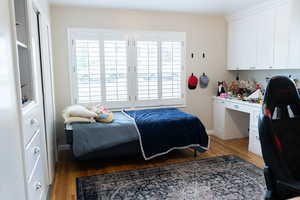Bedroom featuring light wood finished floors and baseboards