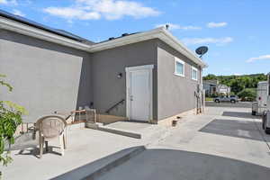 Entrance to property with a patio area and stucco siding