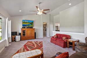 Living area featuring light carpet, a ceiling fan, recessed lighting, and high vaulted ceiling