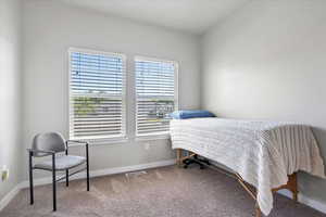 Carpeted bedroom with baseboards