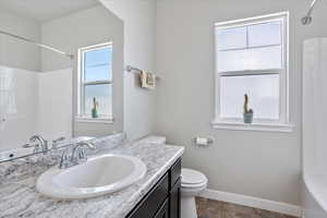 Bathroom with vanity and bathtub / shower combination