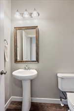 Half bathroom featuring wood finished floors