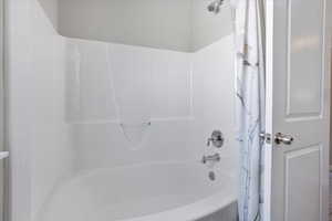 Bathroom featuring shower / bath combo with shower curtain