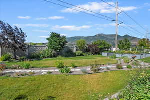 Fenced yard featuring a mountain view