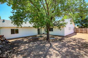 Back of property featuring an outdoor fire pit