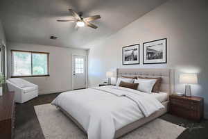 Bedroom featuring vaulted ceiling, dark colored carpet, and ceiling fan
