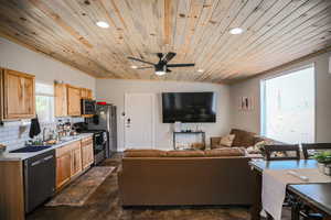 Kitchen featuring appliances with stainless steel finishes, recessed lighting, wooden ceiling, light countertops, and backsplash