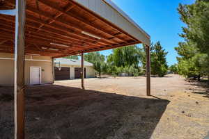 View of yard with a garage and an outdoor structure