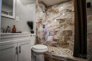 Full bathroom with tiled shower and vanity