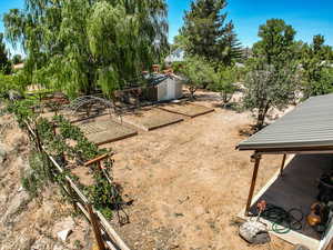 View of yard featuring a garden and a shed