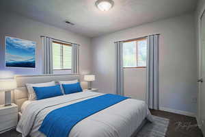 Bedroom featuring dark colored carpet and baseboards