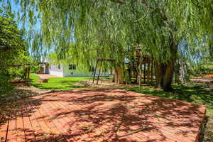 Wooden deck featuring a yard and a patio area
